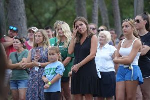 While former students of auto collision teacher Jeff Wilson talk about the memories they made in his class, Greentree Elementary assistant principal Monica Schultz wipes tears from her eyes. Schultz organized the prayer vigil to pray for everyone affected by the floods in Central Texas. 