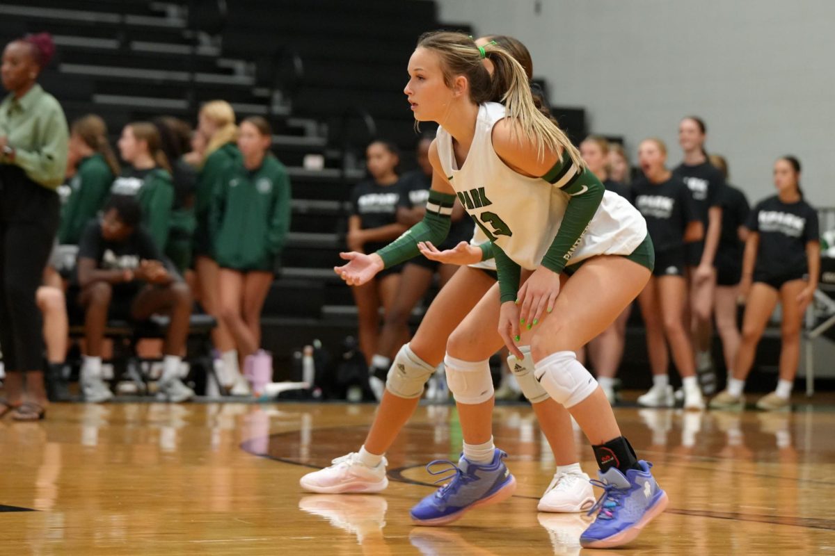 While waiting for a Rudder player to serve the ball, junior Hadley Heineman watches in the back row. 
