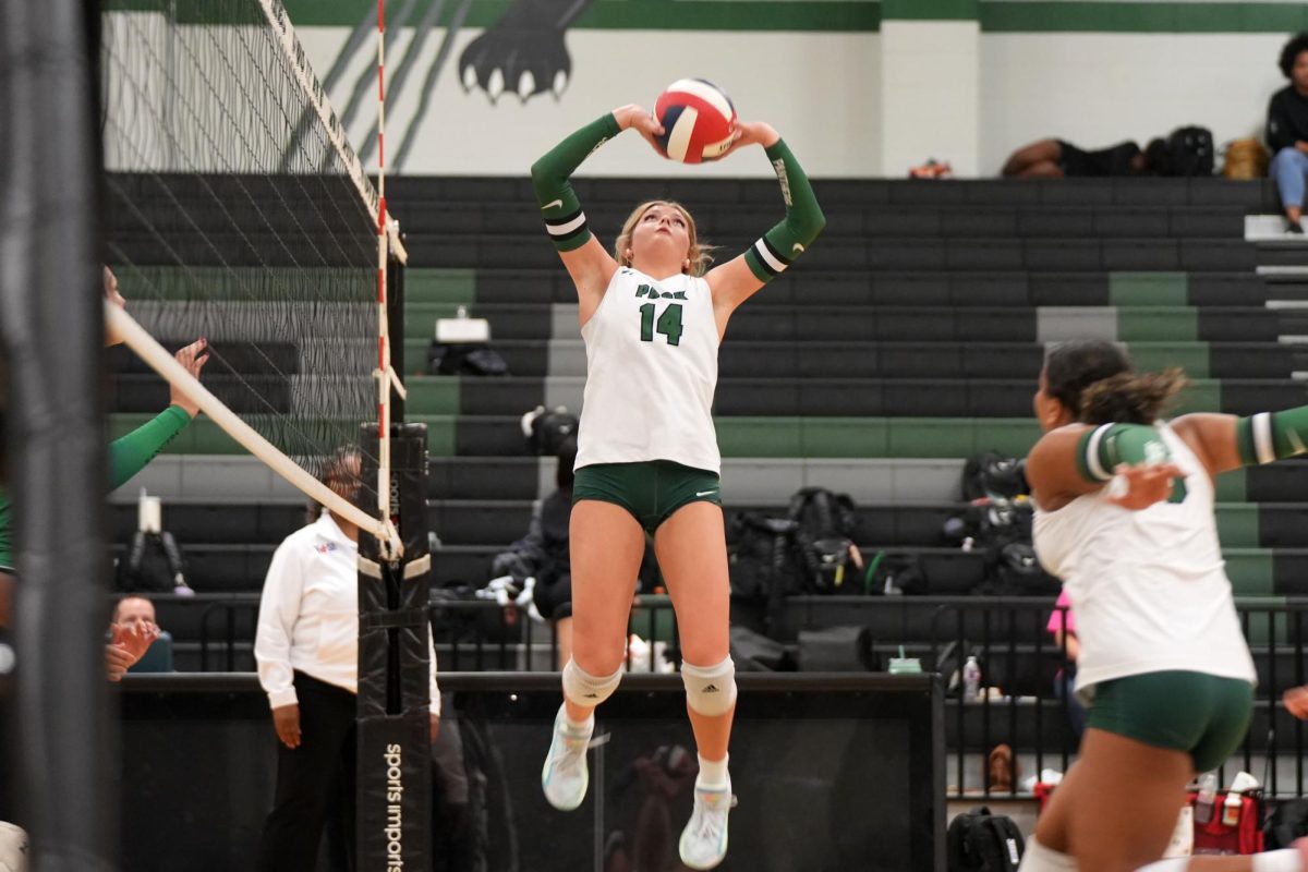 Senior Kaely Evans sets the ball for senior Olivia Parker. The team won, 3-1, against Rudder and will play Kingwood at home on Aug. 29.