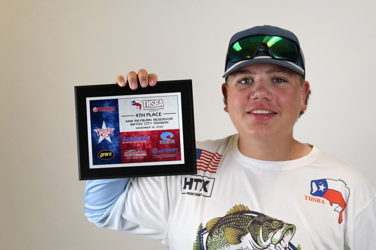 Austin Cater showcases the plaque he won from the Rayburn Reservoir Tournament.
