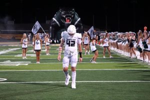 Senior Hagen Smith stands in front of the panther tunnel before the team runs out to start the second half.