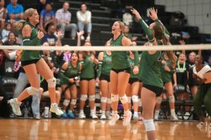 The volleyball team celebrates a point in their 4-1 victory over Kingwood on Aug. 29. 