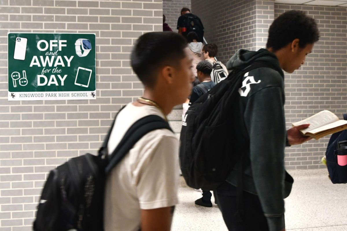 Reminders of the new phone and personal communication device policy hang throughout the hallways in the school.