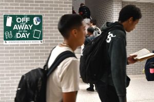 Reminders of the new phone and personal communication device policy hang throughout the hallways in the school.