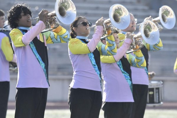 Band members play the mellophones in unison during the band show on Sept. 27 at Turner Stadium. This year's competition performance is called "Oh, the Place's You'll Go!"