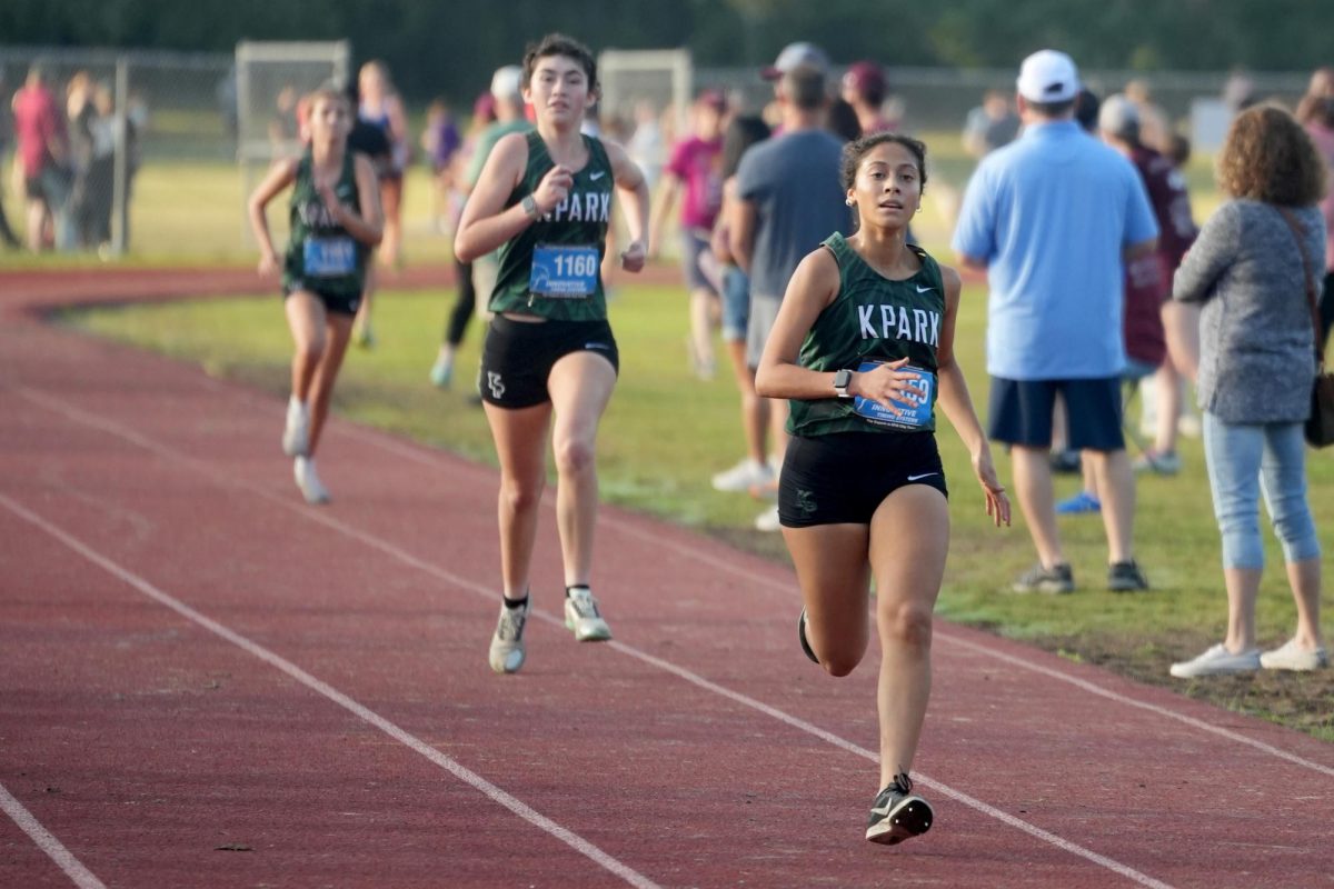 Junior Sylvana Lopez Andrade sprints to the finish at Creekwood Middle School with sophomore Eva Grunz close behind. 