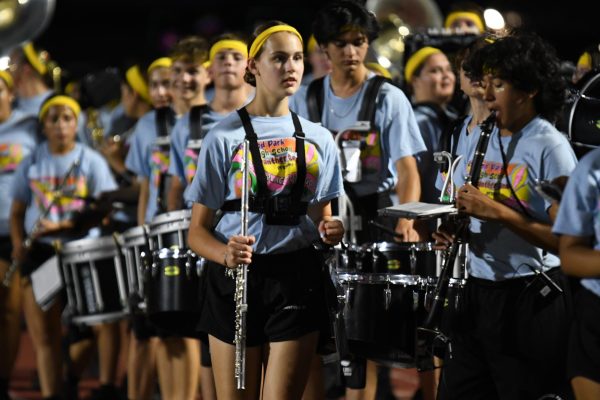 Freshman Peyton Chesney steps off the field after performing with the marching band at halftime of the football game on Sept. 13.