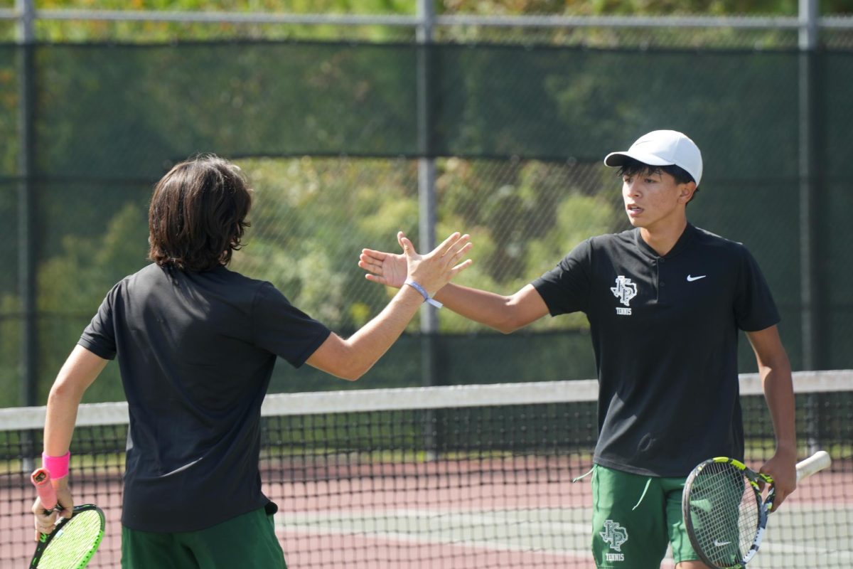 Senior Edun Almeda and sophomore Jaylen Macapaz go to shake hands with each other after scoring against Montgomery.