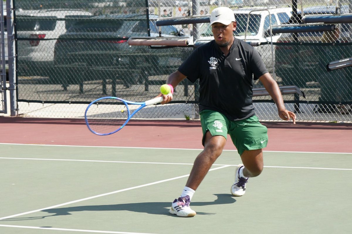 Senior Andres Campos hits the ball back to Montgomery’s side of the court in the doubles match that lasted two and a half hours.