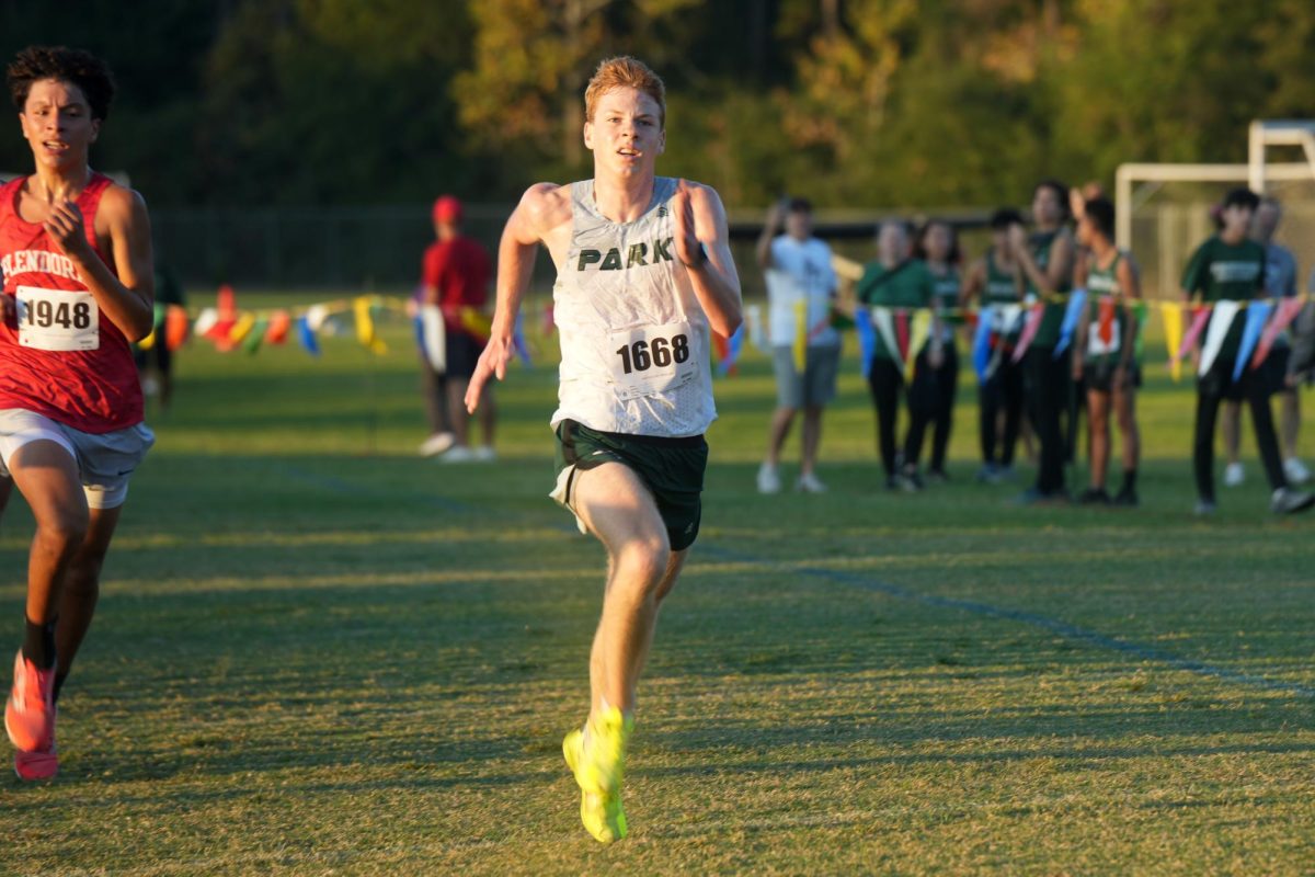 In the last 200m of the 5000m race, senior William Burningham sprints to the finish line. Burningham and the boys team got first in the district, beating Dayton by one point.