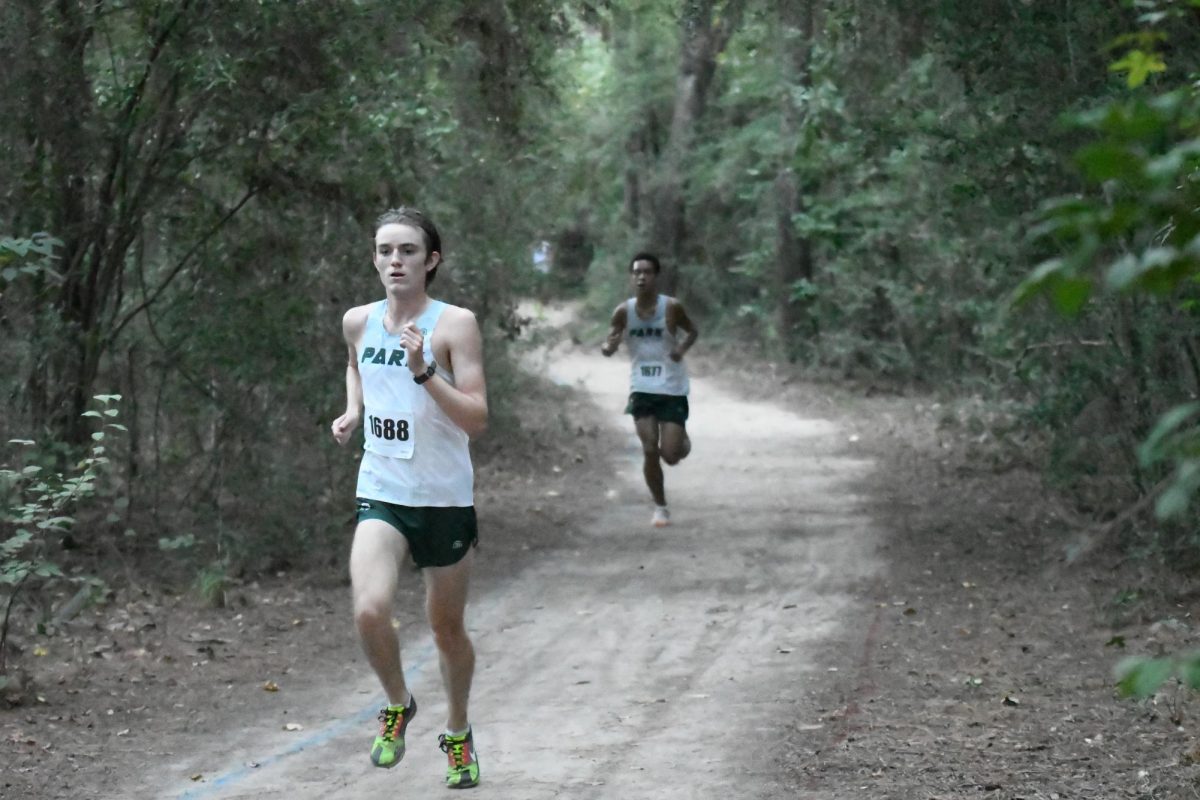 Looking ahead, junior Brett Peveto runs in the varsity 5000m race at the District Meet. The boys team finished in first, with Peveto finishing 5th. 