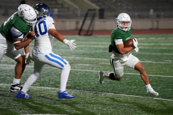 Senior Cooper Wolocko runs with the ball after getting a handoff from senior Bryce Gerbasich, who played backup quarterback during the second half. On Oct. 30, the Panthers lost to Friendswood 34-20.