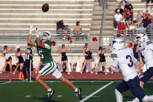 Senior Dane Solomon catches a pass from sophomore quarterback Jon Pavlatos for the first touchdown of the game. The team won 50-47 against Clear Lake. 