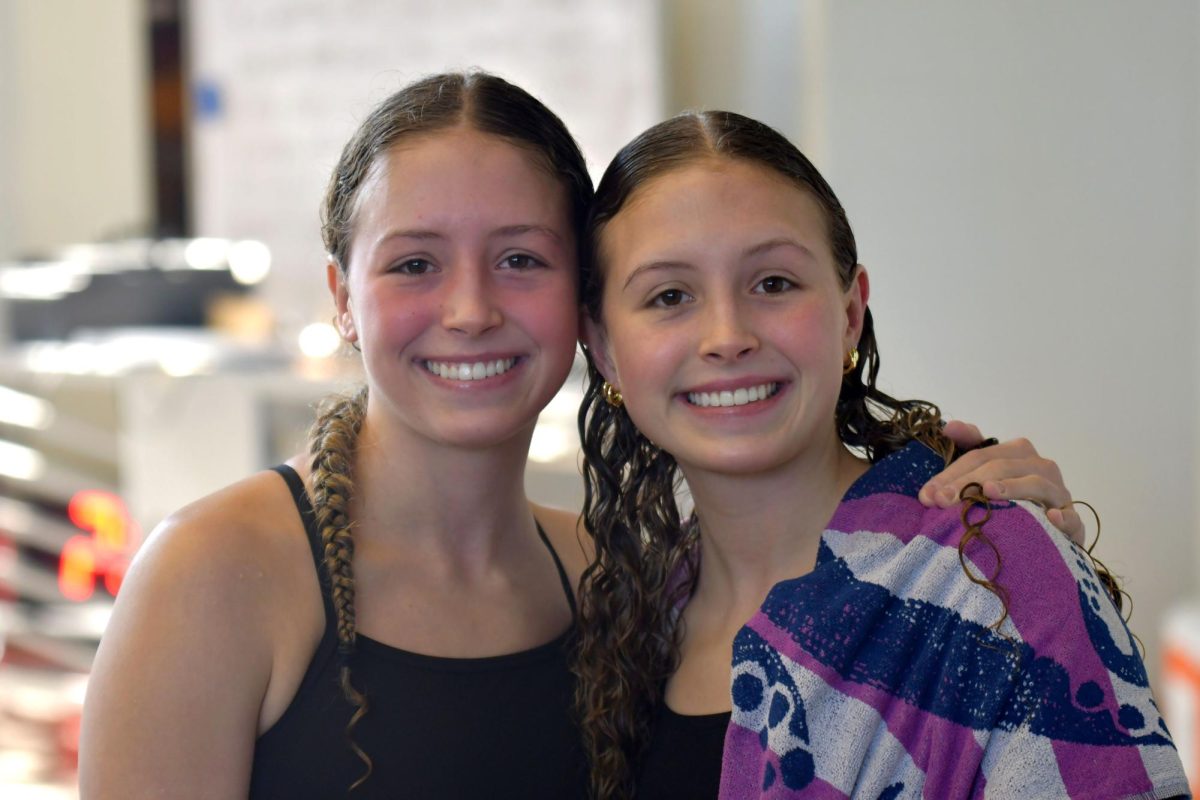 Juniors Allison and Melanie Fixmer challenge each other and cheer each other on as part of the varsity swim team.