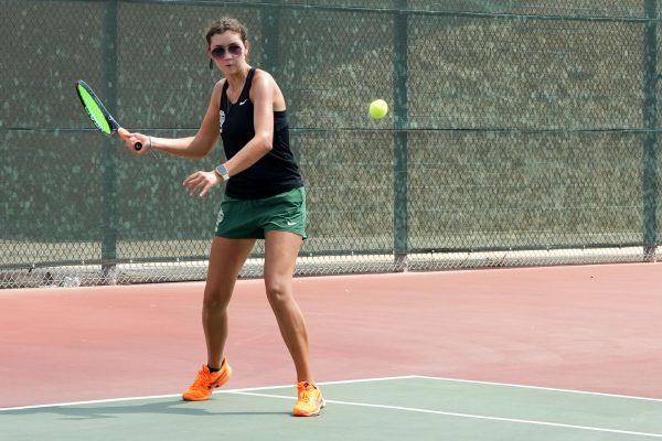 Senior Isabella Sikora hits the ball against a Magnolia player on Aug. 8. Sikora capped off her fall season with district MVP honors for the second year in a row.