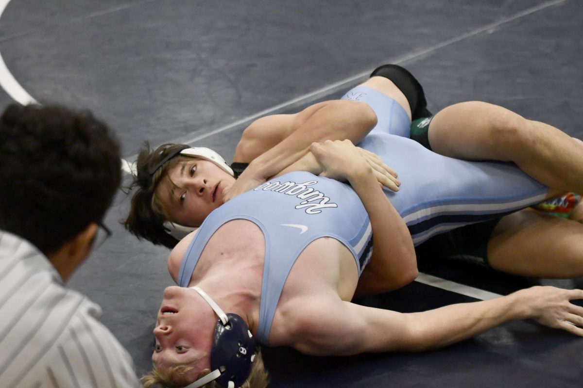 Senior Tristan Rodriguez looks to the ref as he works to pin his opponent in a dual against Kingwood on Nov. 12. Rodriguez is trying to become the first boy in the wrestling program to win four district titles.