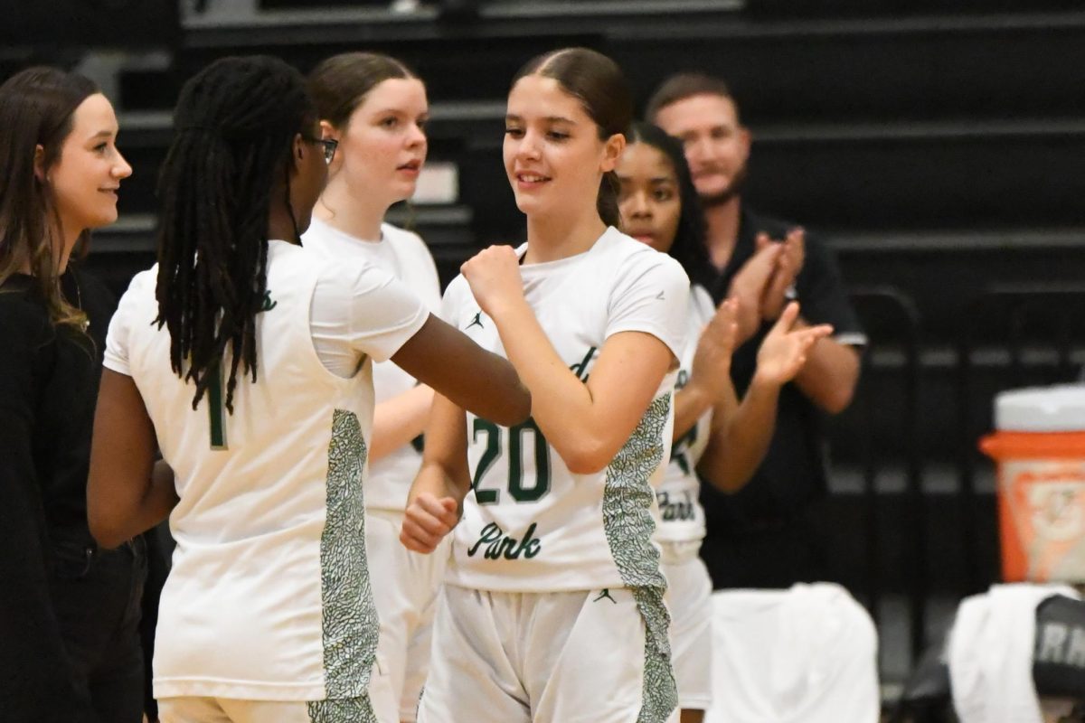 During player announcements, sophomore Aubrey Keim shakes hands with sophomore Lyric Russell. The Panthers competed against West Brook on Dec. 9.
