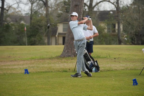 Sophomore Parker McGehee watches his ball in the back swing during a tournament at Atascocita last spring.  McGehee will return back as a top player this year.