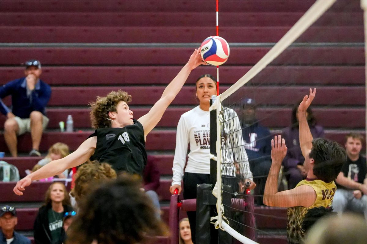 Junior Asher Rennard tips the ball over the net in a boys volleyball game against Summer Creek on March 5, 2025. Kingwood Park created a boys volleyball club team that competes against local schools, since it is not a UIL-sanctioned sport.