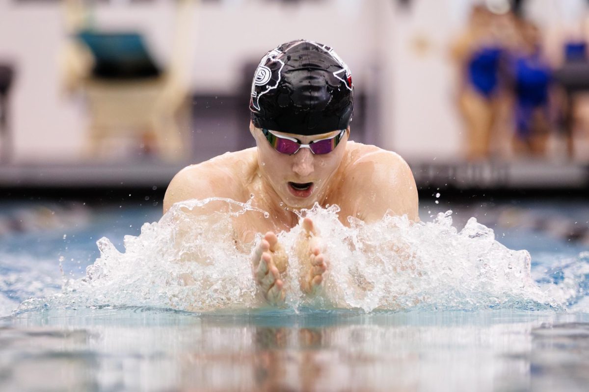 Senior Brody Burns competes in the breaststroke during the Senior Night meet on Jan. 9. Photo courtesy of Tim Sullivan. 