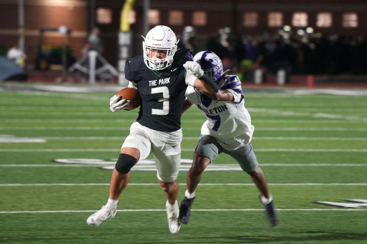 While an Angleton defender attempts to tackle him, senior Cooper Wolocko runs with the ball during the first quarter. On Oct. 17, the Panthers lost to Angleton, 67-13. 