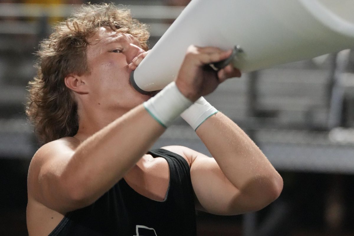 Sophomore Carson Kee cheers during the Dayton football game on Sept. 5. He joined the cheer team his sophomore year and will be a walk-on on the Mississippi State cheer team next year.