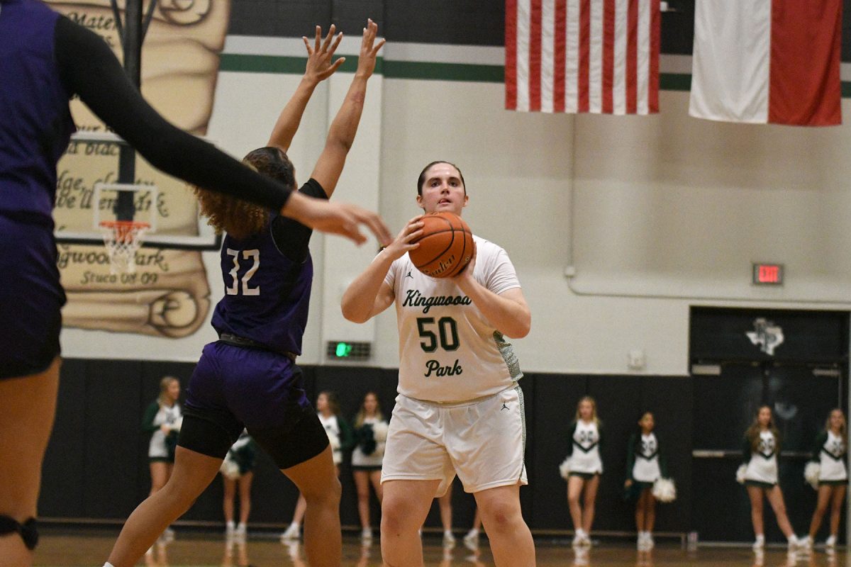 While a Dayton player is closing out, senior Kendall Olson shoots an attempt from the top of the key. On Jan. 9, the Panthers lost to Dayton, 29-51, in a district matchup. 