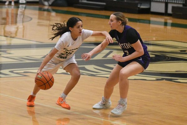 Dribbling up the court, freshman Annie Salazar looks forward while attempting to go past a Dayton defender. 