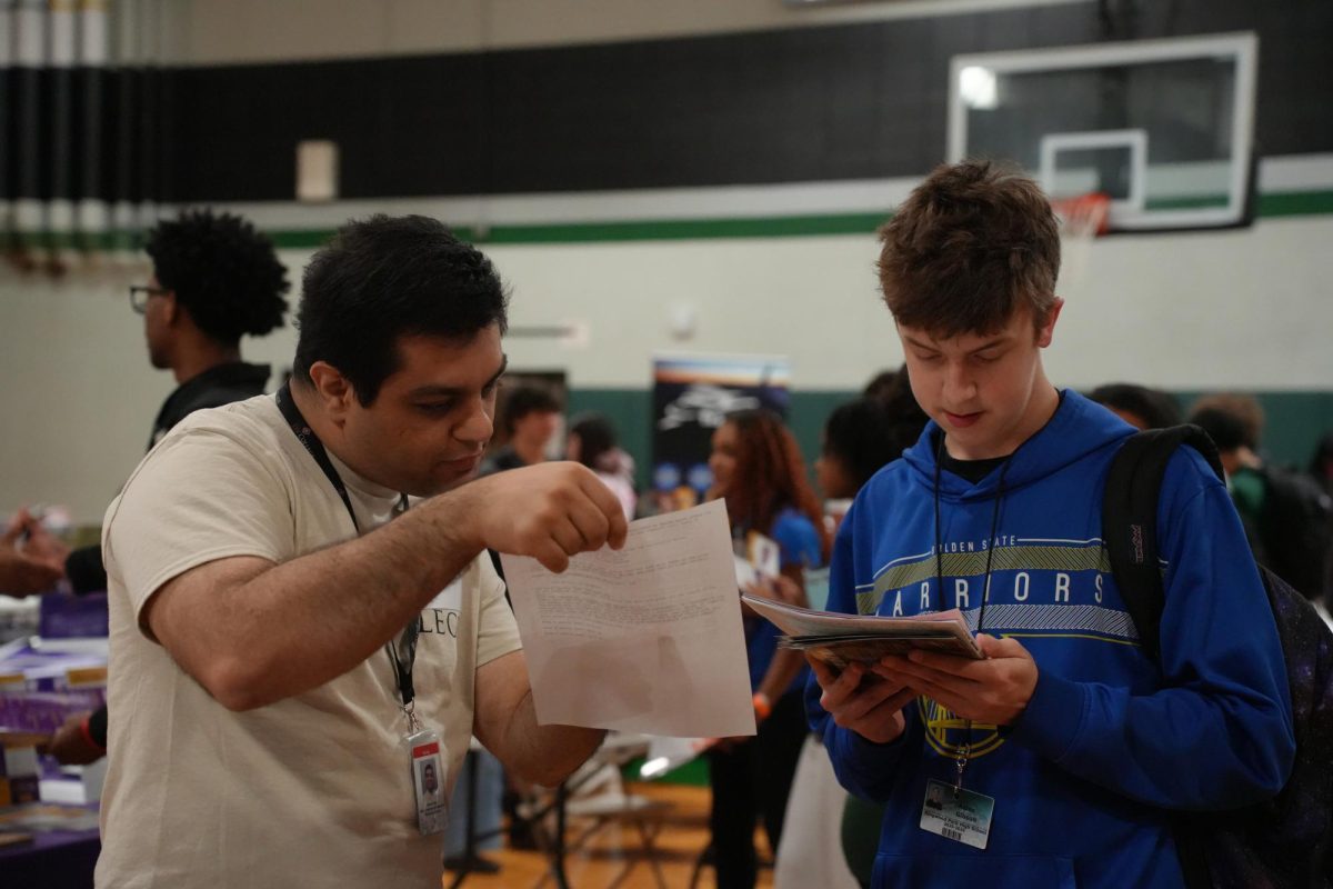 Junior Aiden Gibson visits with a college recruiter to see what programs and majors are offered.