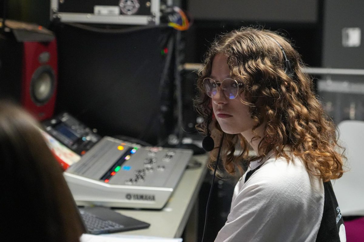 Junior Viviana Diaz-Jones works on "Sweeney Todd" as the stage manager during dress rehearsal earlier this month.