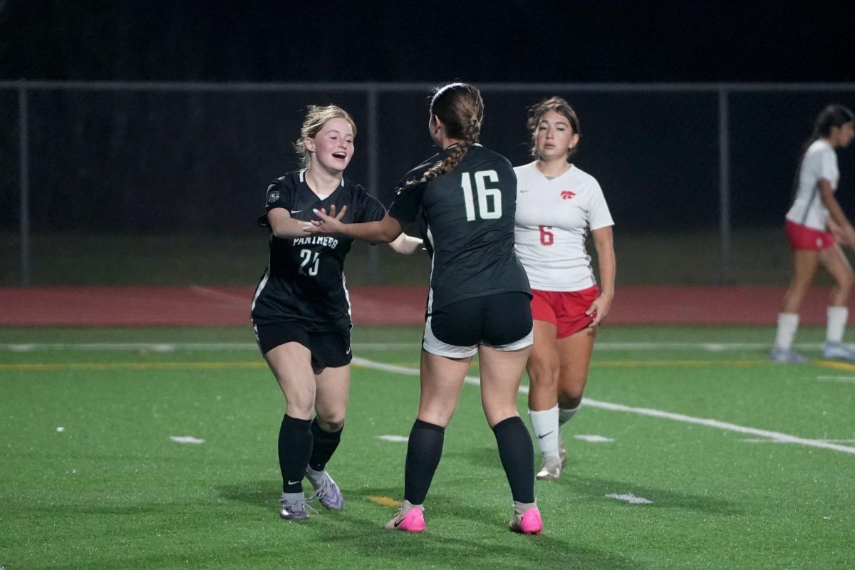 Sophomore Charlie Crass and senior Emma Campbell celebrate after Campbell scored a goal during the second half of the game against Splendora. 