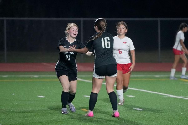 Sophomore Charlie Crass and senior Emma Campbell celebrate after Campbell scored a goal during the second half of the game against Splendora. 