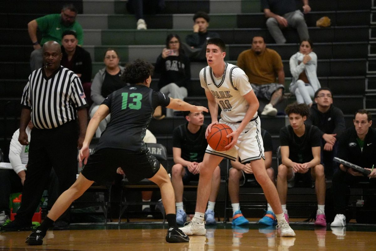 Looking into the paint, senior Landen Hansen holds the ball before passing it to one of his teammates. On Feb. 17, the team competed in their last district game against Pasadena and won 46-42.