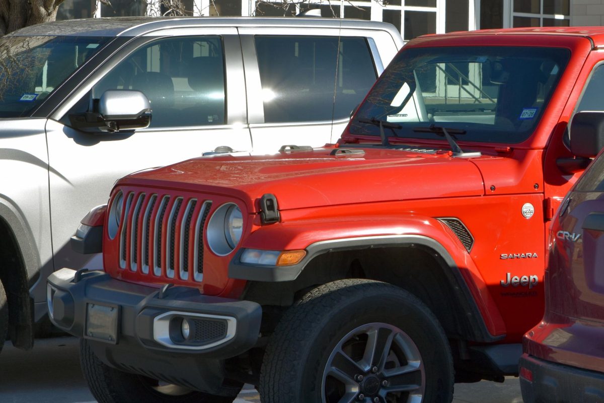 A red Jeep sits in the fine arts parking lot during the school day. Many students who drive to school have found struggles while driving in the Kingwood area.