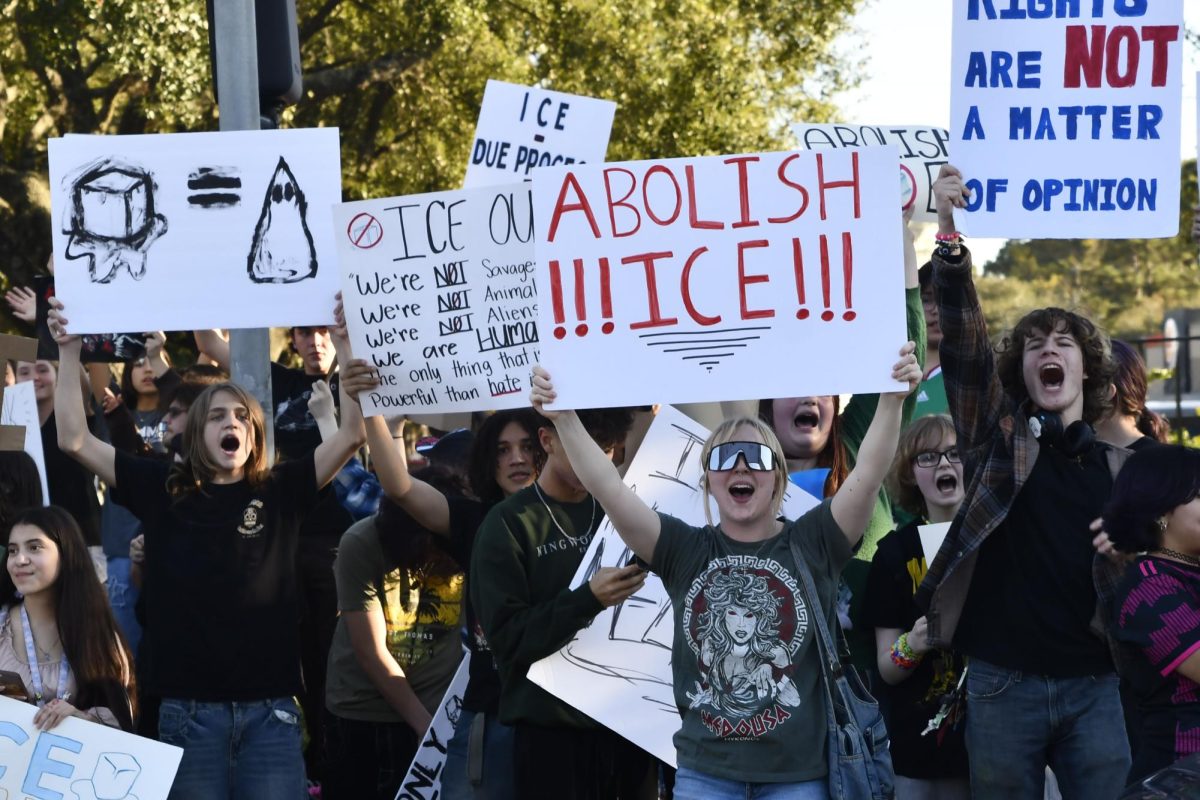 Kingwood and Kingwood Park students converge at the busy intersection of Kingwood Drive and West Lake Houston Parkway on Feb. 6 to protest Immigration and Customs Enforcement.