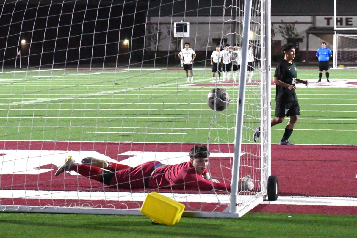 Senior Joaquin White sinks his penalty kick into the back of the net against Rudder in a win in the first round of playoffs on March 20. 