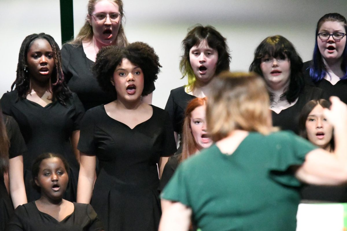 Senior Amara Amadi watches director Christine Donley as she performs with fellow choir members in the UIL preview show in March. Amadi became the choir's only All-State choir student this year.