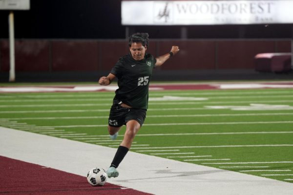 During the first period of overtime, senior Eddie Hernandez kicks the ball from the midfield. 
