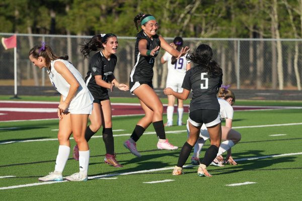 In the middle of the second half, sophomore Liani Villegas and freshman Carmen Johnson jump in celebration after senior Alexis Carbajal scored a goal. Carbajal scored one of three goals in the team's victory against College Station. 