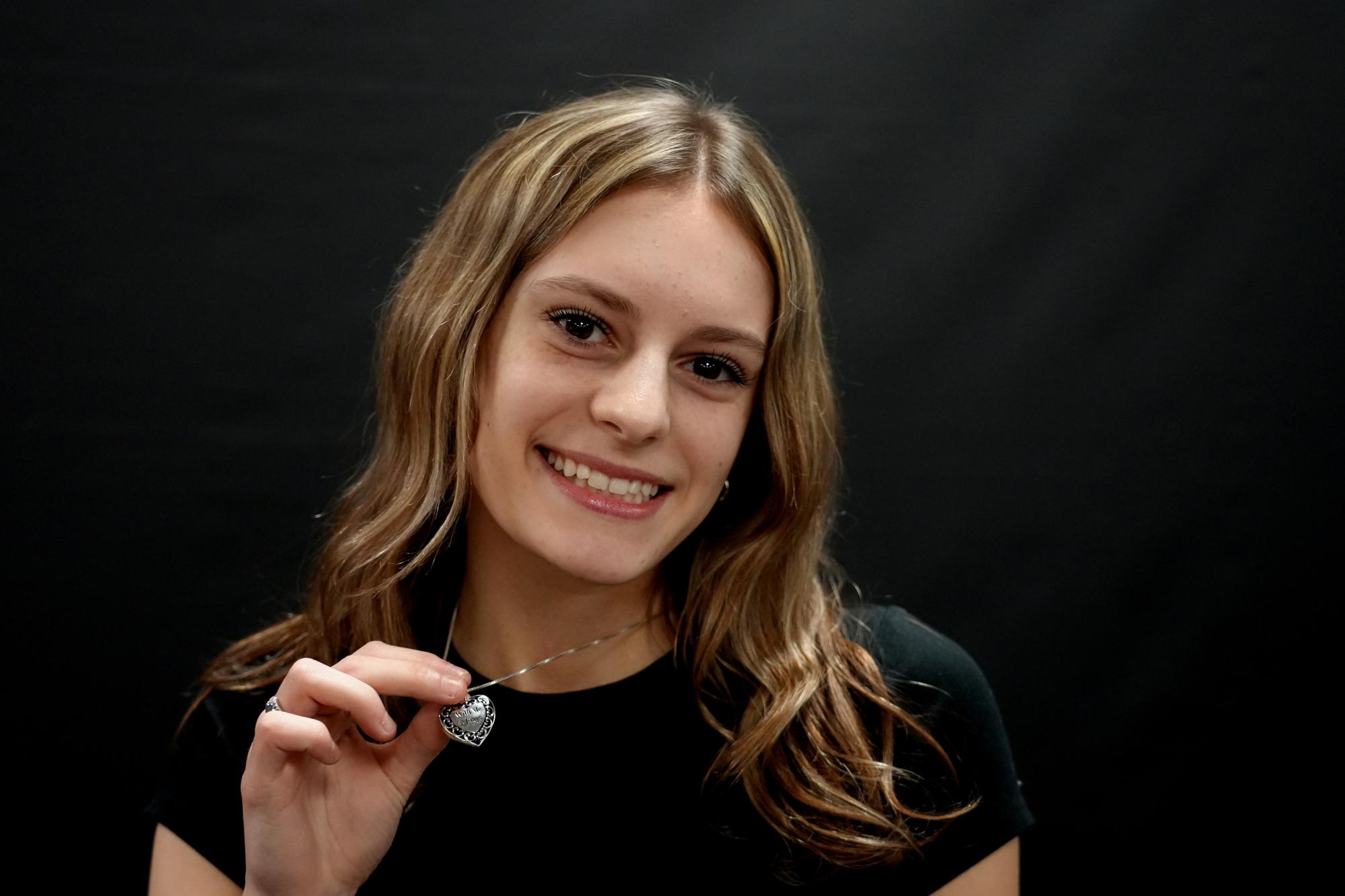 Junior Madalyn Danley Butler shows off a pendant she received from the funeral home with her pawpaw’s ashes inside it after he passed away in January 2024.