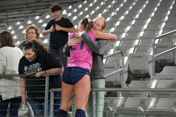After losing in the Regional Final matchup against A&M Consolidated,  junior goalkeeper Peyton Smithson hugs 2024 Kingwood Park graduate Arleigh Doehring. 
