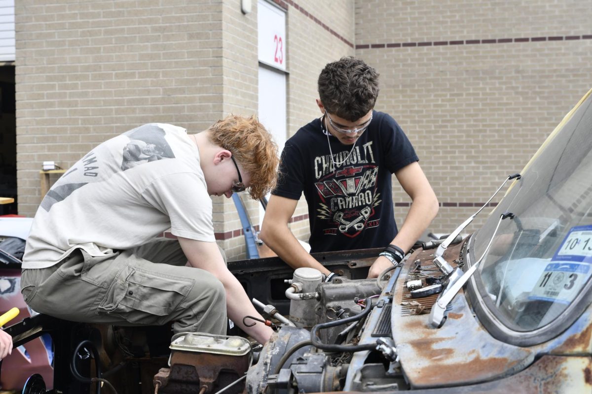 Freshman Aiden Stout and sophomore Jake Whitley work on fixing up an ‘82 C-10 during Automotive Basics class.