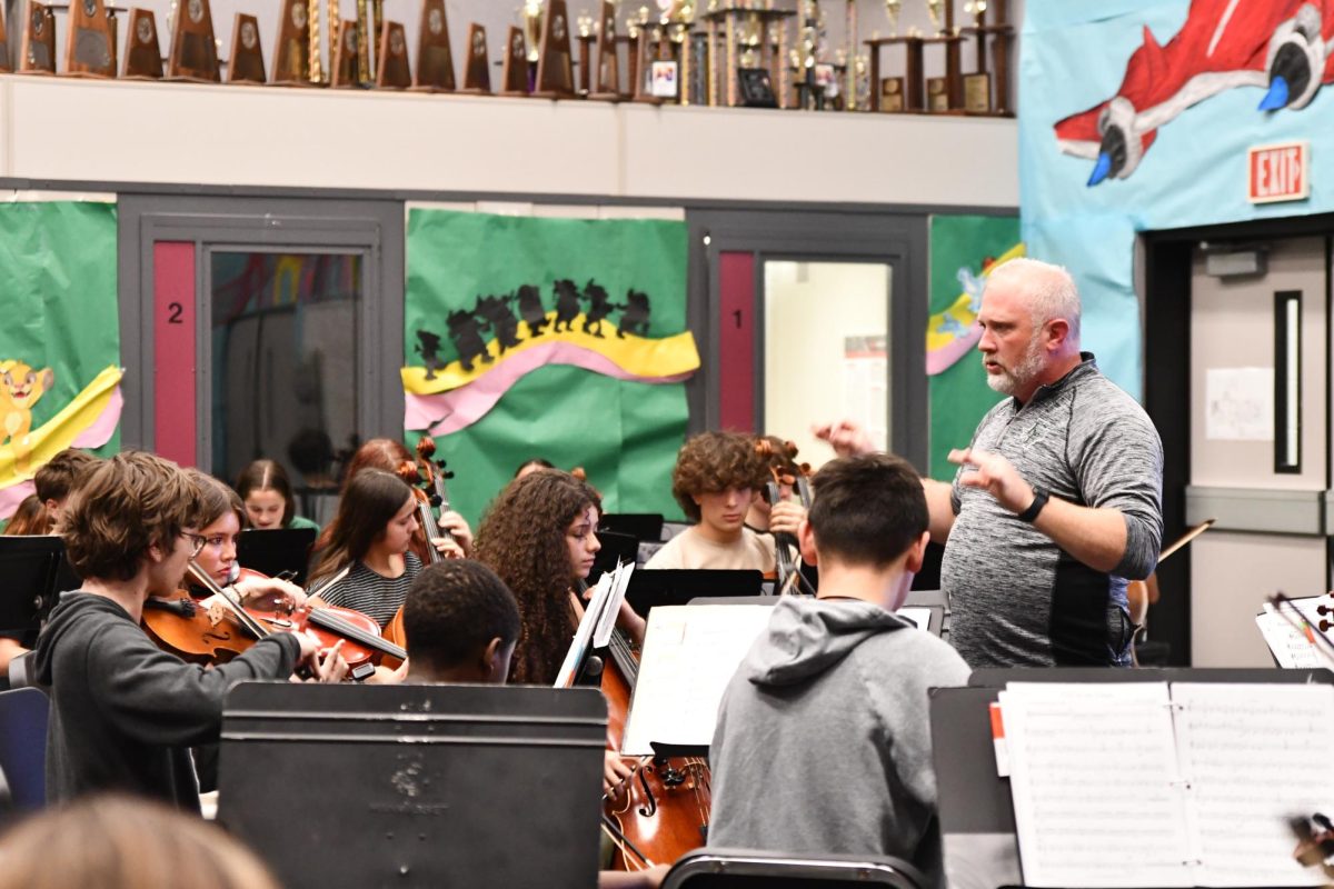 Director Evan Farmer leads the orchestra in practice on April 23. The large group was headed to its final competition in San Antonio on April 24. 