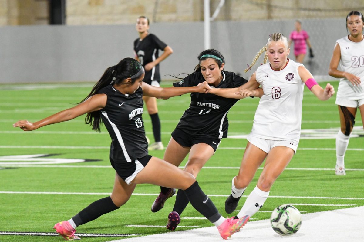 Freshman Carmen Johnson and freshman Lyla Hernandez play defense on an A&M Consolidated player and attempt to steal the ball. 