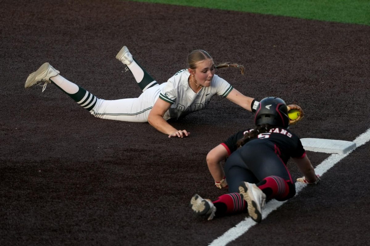 Junior Allie Minick slides into first base in an attempt to get a Porter player out. The player was called out, before the Panthers lost the district matchup, 8-6.