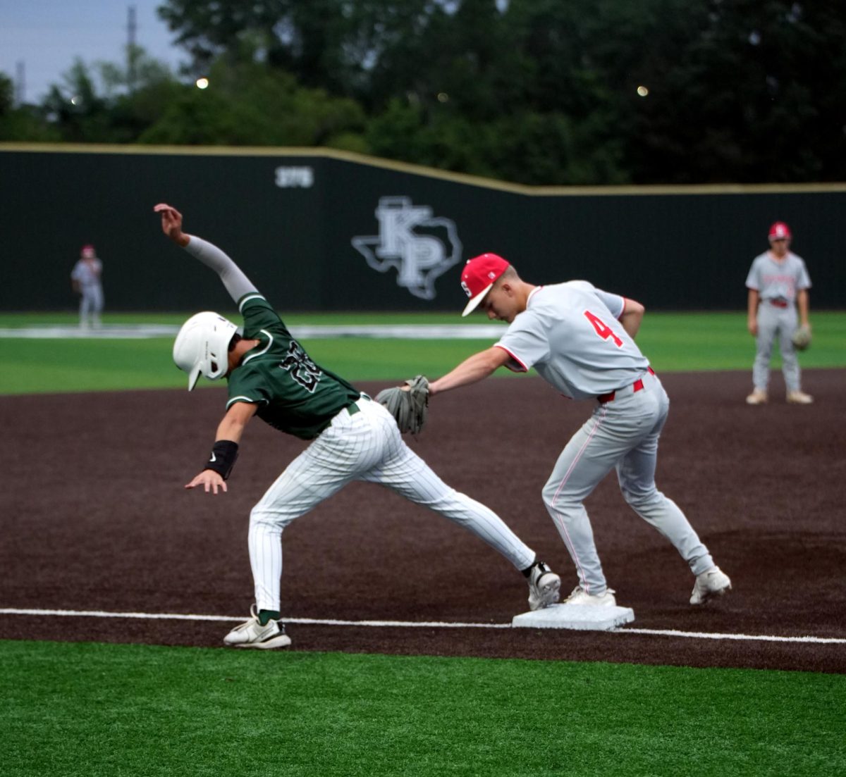 Senior Dylahn Bodkin holds his balance on third base while a Splendora infielder attempts to tag him out. The Panthers won the matchup against Splendora, 8-2. 
