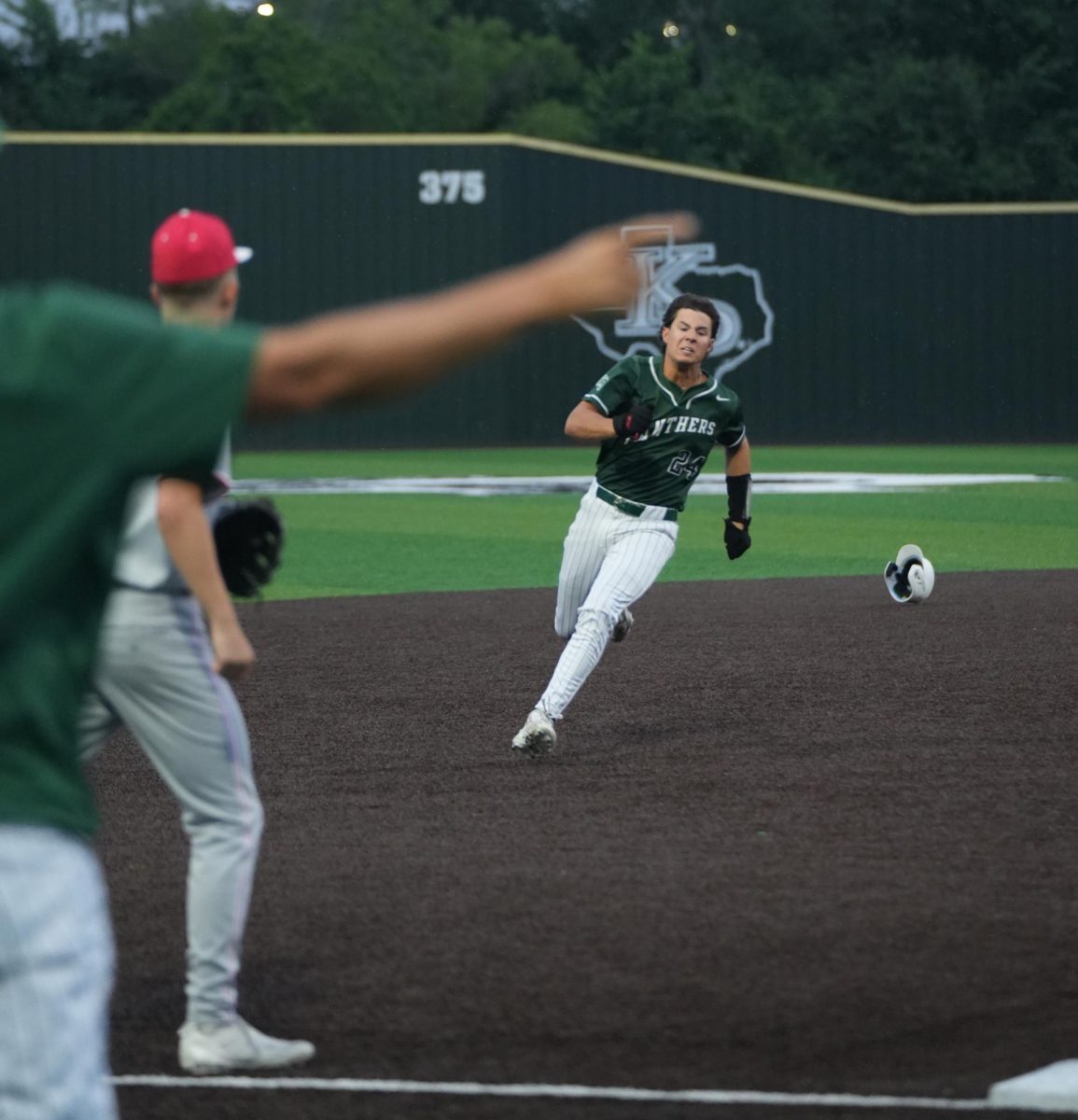 Looking ahead, senior Michael Segura runs to third as one of his coaches points towards the home plate. The baseball team won the game against Splendora, 8-2 on April 20. 