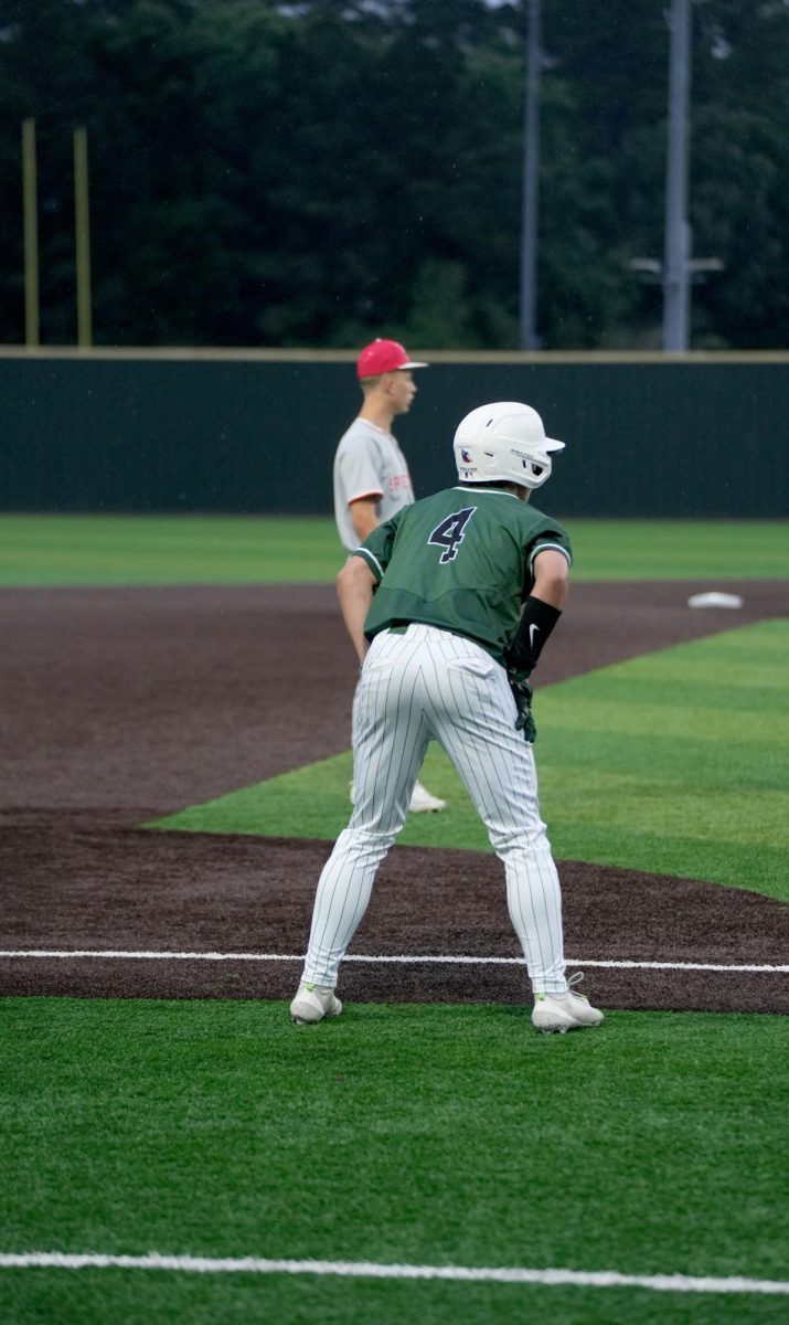 While standing on third base, junior Logan Coburn watches the Splendora pitcher while looking to score a run. 
