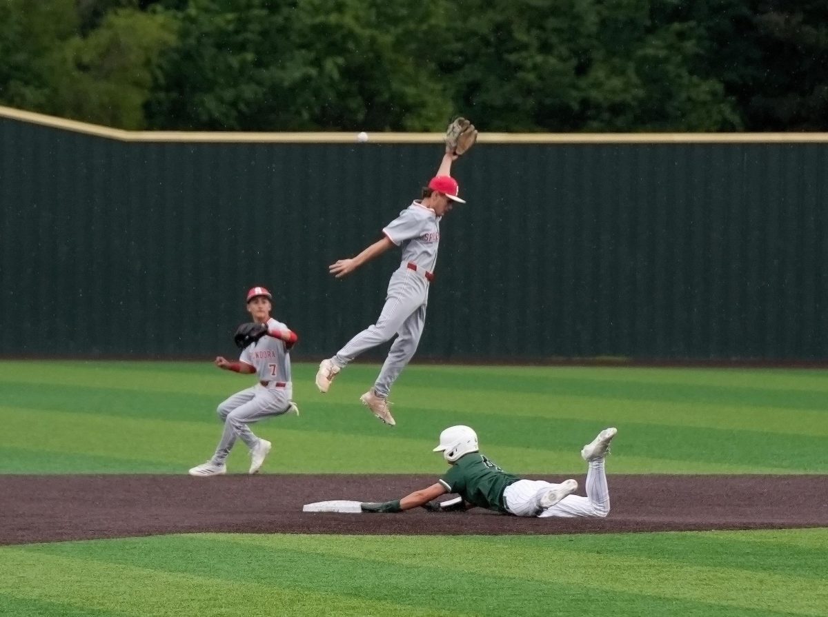 As Splendora infielder jumps to the ball, junior Logan Coburn slides in to steal second base. The baseball team competed in the district matchup against Splendora on April 20 and won 8-2. 
