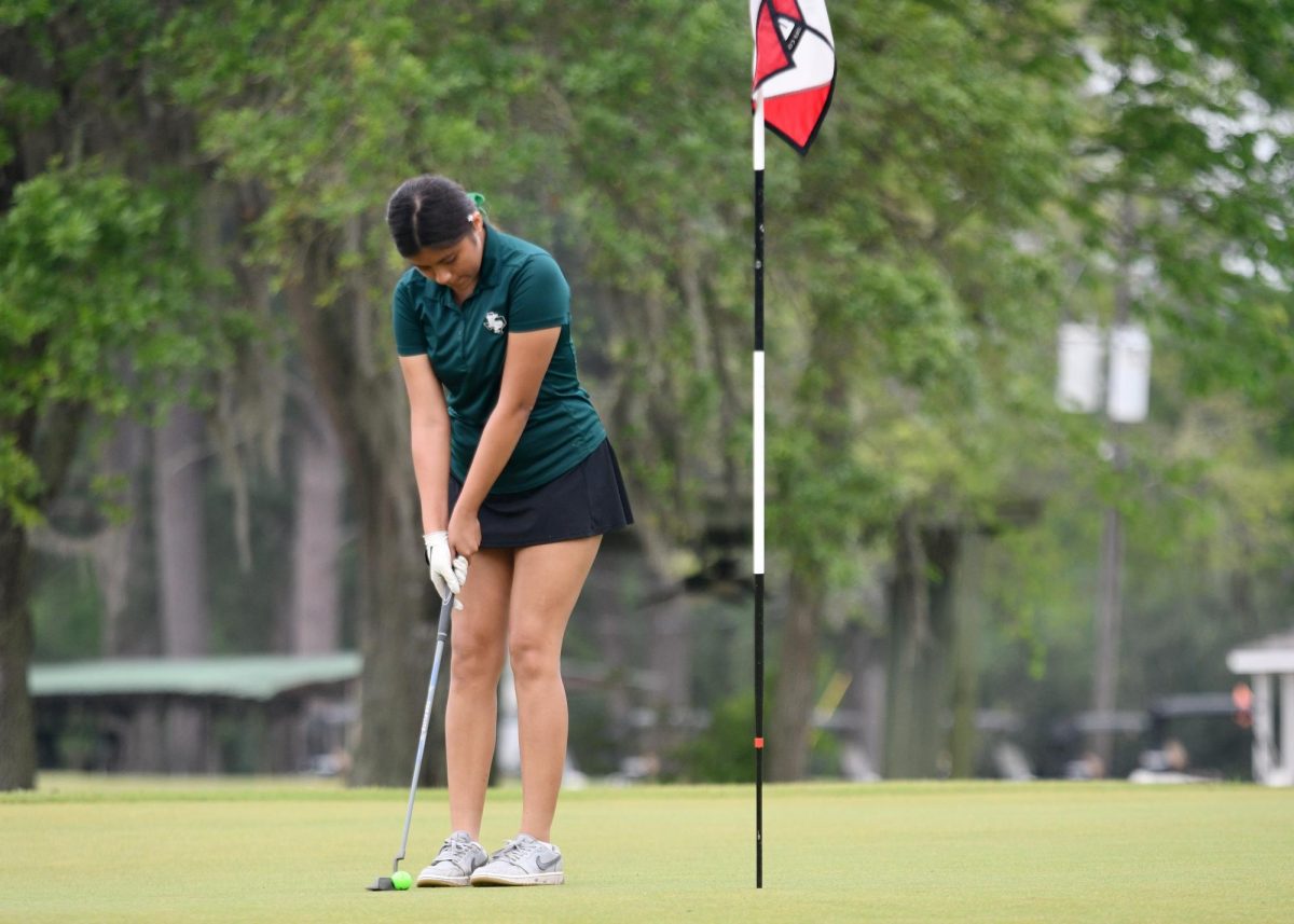 Sophomore Haley Peña putts during the District Meet for the JV team, which finished in second place.